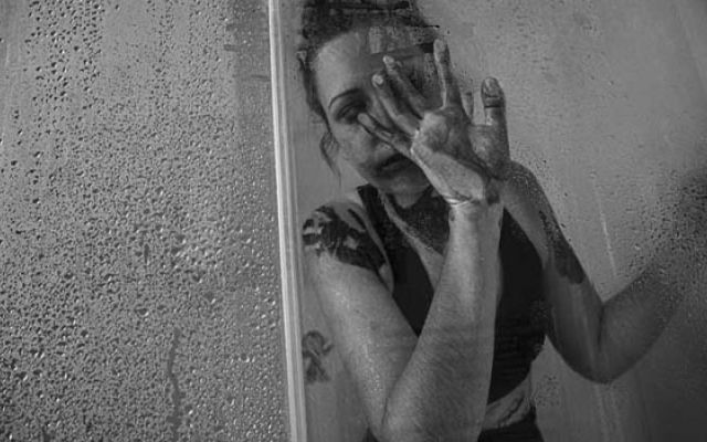 woman crying in the shower