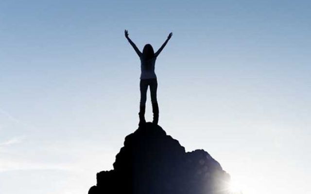 woman over the top of a mountain