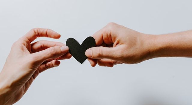two hands with a heart