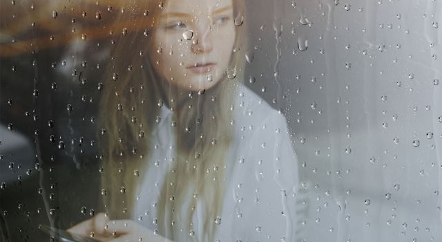 woman looking through a window