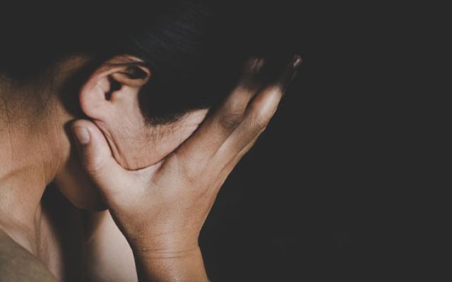 woman covering her face