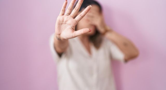 woman covers face