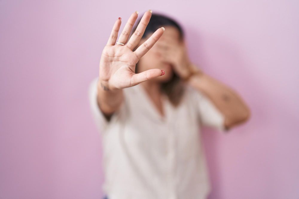 woman covers face