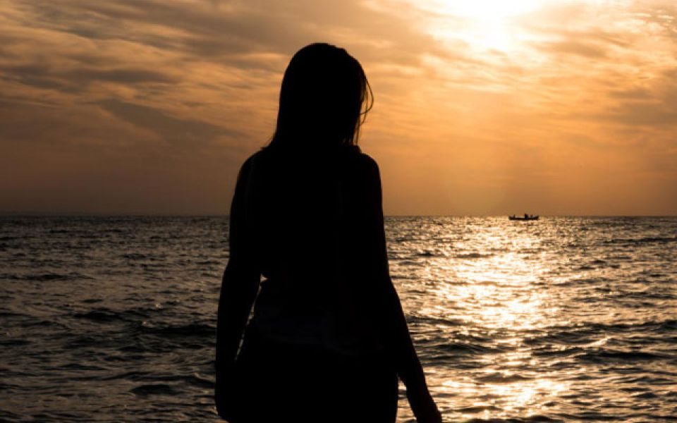 woman looking at sunset