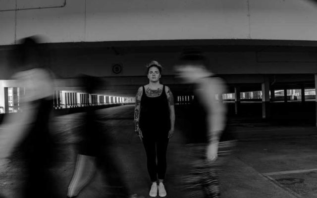 standing woman in a passing crowd