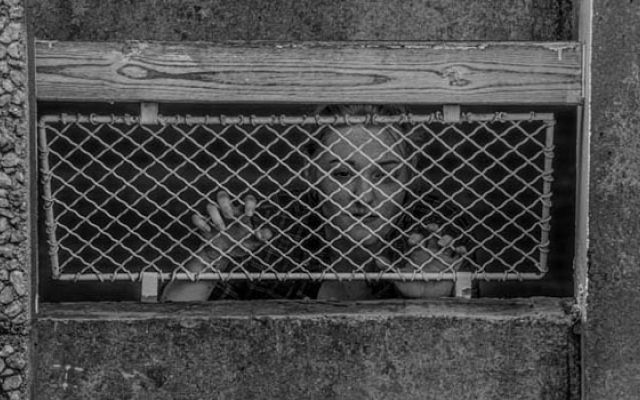 caged woman in greyscale